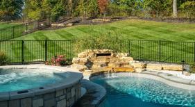 Rock-waterfall-with-raised-spa-in-a-fiberglass-pool